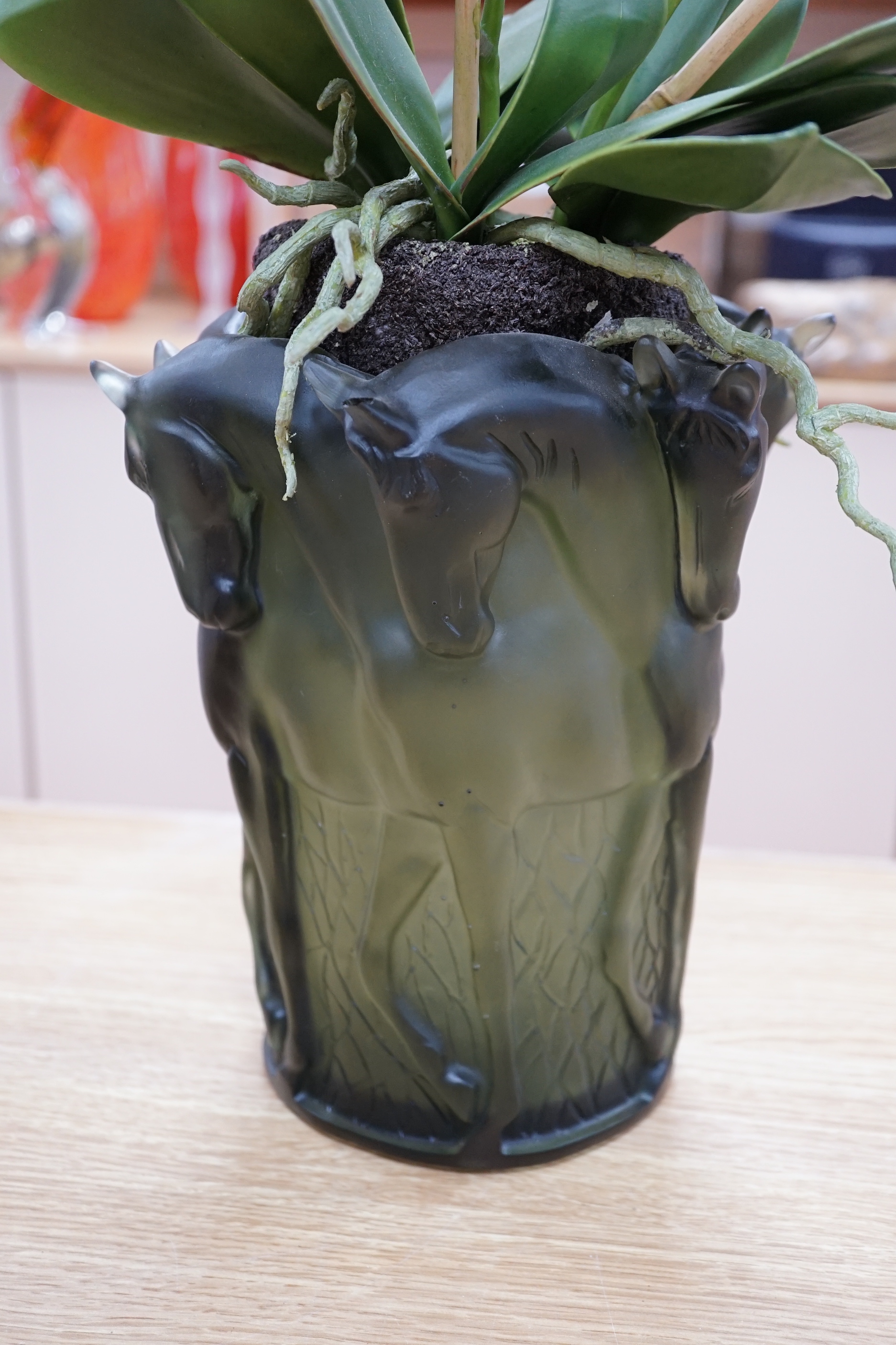 A pair of green glass Lalique style 'Haviland' signed vases with horse design and faux orchid plants within, 26cm high